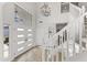Spacious foyer with stairs, wood floors, and modern lighting offers a bright entry at 11089 N 130Th Pl, Scottsdale, AZ 85259