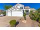 Charming two-story home featuring a three-car garage and beautifully landscaped front yard at 11089 N 130Th Pl, Scottsdale, AZ 85259