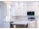 Updated kitchen features white cabinets, quartz counters, and an island with bar seating at 11089 N 130Th Pl, Scottsdale, AZ 85259