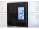 Sleek, smart refrigerator featuring Gathering hub touchscreen, built into custom kitchen cabinetry at 11089 N 130Th Pl, Scottsdale, AZ 85259