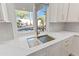 Modern kitchen sink, quartz counters and an outdoor view of landscaping and a pool at 11089 N 130Th Pl, Scottsdale, AZ 85259