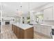 Spacious open kitchen with white cabinets, stone counters, an island and stylish pendant lighting at 11089 N 130Th Pl, Scottsdale, AZ 85259