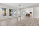 Spacious living room open to the kitchen, featuring wood floors and large windows at 11089 N 130Th Pl, Scottsdale, AZ 85259
