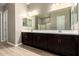 Bathroom featuring a double vanity with dark cabinets and a large mirror at 1255 N Arizona Ave # 1300, Chandler, AZ 85225