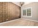 Bedroom featuring a textured accent wall and plantation shutters at 1255 N Arizona Ave # 1300, Chandler, AZ 85225