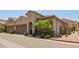 Beige two-story home with a two-car garage, tile roof, and desert-friendly landscaping, offering charming curb appeal at 1255 N Arizona Ave # 1300, Chandler, AZ 85225