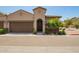 Inviting beige two-story home featuring a tile roof, two-car garage, and well-maintained landscaping at 1255 N Arizona Ave # 1300, Chandler, AZ 85225