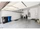 Spacious garage with sealed concrete floor, storage racks, and water heater at 1255 N Arizona Ave # 1300, Chandler, AZ 85225