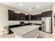 Granite countertops, stainless steel appliances and dark cabinets define the stylish kitchen at 1255 N Arizona Ave # 1300, Chandler, AZ 85225