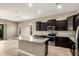 Modern kitchen featuring stainless appliances, granite countertops, and an island with a sink at 1255 N Arizona Ave # 1300, Chandler, AZ 85225