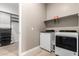 Bright laundry room featuring a washer, dryer, shelving, and tile floor at 1255 N Arizona Ave # 1300, Chandler, AZ 85225