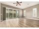 Light-filled living room with wood floors, large windows, and shutters for a blend of style and comfort at 1255 N Arizona Ave # 1300, Chandler, AZ 85225