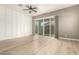 Bright living room boasts hardwood floors, sliding glass doors, and decorative accent wall for modern charm at 1255 N Arizona Ave # 1300, Chandler, AZ 85225