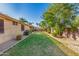 Spacious backyard with lush green grass, mature trees, and a serene, private setting at 1474 E Locust Dr, Chandler, AZ 85286