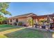 Inviting backyard with a covered patio, outdoor seating, and well-maintained landscaping at 1474 E Locust Dr, Chandler, AZ 85286