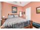 Cozy bedroom features a wooden bed frame, unique bedding, and warm, inviting wall color at 1474 E Locust Dr, Chandler, AZ 85286