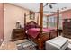 Cozy main bedroom featuring a four-poster bed and ample natural light from the window at 1474 E Locust Dr, Chandler, AZ 85286