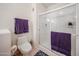 Modern bathroom with a glass-enclosed shower, a toilet, and a towel rack with violet towels at 15225 N 100Th St # 1185, Scottsdale, AZ 85260