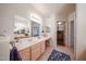 Elegant bathroom with double vanity, large mirror, and access to a walk-in closet, blending style and functionality at 15225 N 100Th St # 1185, Scottsdale, AZ 85260