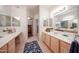 Bright bathroom featuring double sinks, a spacious vanity area, and a separate walk-in closet at 15225 N 100Th St # 1185, Scottsdale, AZ 85260