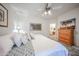Comfortable bedroom featuring a large bed, ceiling fan, and doorway leading to the bathroom at 15225 N 100Th St # 1185, Scottsdale, AZ 85260