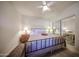 Inviting bedroom with iron bed frame, ceiling fan and mirrored closet doors at 15225 N 100Th St # 1185, Scottsdale, AZ 85260