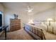 Cozy bedroom with neutral carpet, a ceiling fan, a dresser, and bedside lamps at 15225 N 100Th St # 1185, Scottsdale, AZ 85260