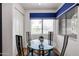 This bright dining area includes a glass-top table for four, and large windows with scenic views at 15225 N 100Th St # 1185, Scottsdale, AZ 85260