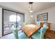 Light-filled dining area with a wood table and colorful seating next to an outdoor patio at 15225 N 100Th St # 1185, Scottsdale, AZ 85260