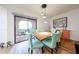 Bright dining space with wood table, puzzle and colorful chairs near outdoor patio access at 15225 N 100Th St # 1185, Scottsdale, AZ 85260