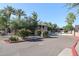 Charming entrance with blooming bushes and secure gated access to the community at 15225 N 100Th St # 1185, Scottsdale, AZ 85260