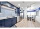 This kitchen features blue cabinets, stainless steel appliances, and a glass-top dining table at 15225 N 100Th St # 1185, Scottsdale, AZ 85260
