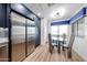 Bright kitchen features stainless steel appliances, hardwood floors, blue cabinets, and a glass-top dining table at 15225 N 100Th St # 1185, Scottsdale, AZ 85260