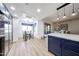 Kitchen with blue cabinets, stainless appliances, glass top table, hardwood floors and lots of sunlight at 15225 N 100Th St # 1185, Scottsdale, AZ 85260