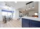 This kitchen features blue cabinets, stainless steel appliances, and a glass-top dining table at 15225 N 100Th St # 1185, Scottsdale, AZ 85260