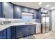 The kitchen features sleek, blue cabinetry, modern appliances, and white countertops at 15225 N 100Th St # 1185, Scottsdale, AZ 85260