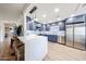 Modern kitchen features a waterfall island, stainless steel appliances, and blue cabinetry at 15225 N 100Th St # 1185, Scottsdale, AZ 85260