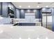 The kitchen features a stainless-steel fridge and appliances, plus blue cabinets and a marble-look countertop at 15225 N 100Th St # 1185, Scottsdale, AZ 85260