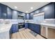 Modern kitchen featuring stainless steel appliances, blue cabinets and white countertops at 15225 N 100Th St # 1185, Scottsdale, AZ 85260