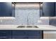 Detail of kitchen with stainless steel sink, mosaic backsplash and stone countertop at 15225 N 100Th St # 1185, Scottsdale, AZ 85260