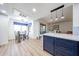 Kitchen with blue cabinets, stainless appliances, glass top table, hardwood floors and lots of sunlight at 15225 N 100Th St # 1185, Scottsdale, AZ 85260