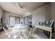 Relaxing covered patio featuring a ceiling fan, glass-top table, seating, and sliding glass door access at 15225 N 100Th St # 1185, Scottsdale, AZ 85260