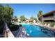 A sunny view of the sparkling community pool and surrounding lounge area at 15225 N 100Th St # 1185, Scottsdale, AZ 85260