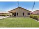 Backyard with a covered patio, outdoor seating, and green artificial turf at 1583 N Constellation Ct, Gilbert, AZ 85234