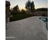 Landscaped backyard with custom patio, manicured lawn, ambient lighting, and refreshing pool, perfect for outdoor enjoyment at 1583 N Constellation Ct, Gilbert, AZ 85234