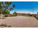 Spacious backyard featuring gravel landscaping, secure fencing, and a low-maintenance design, perfect for outdoor activities at 1583 N Constellation Ct, Gilbert, AZ 85234