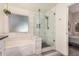 Modern bathroom featuring a glass-enclosed shower, soaking tub, and elegant tile work for a spa-like experience at 1583 N Constellation Ct, Gilbert, AZ 85234