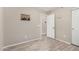 Bedroom with neutral paint, baseboards and wood-look tile flooring at 1583 N Constellation Ct, Gilbert, AZ 85234