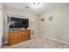 Bedroom with natural wood dresser and wood-look tile flooring at 1583 N Constellation Ct, Gilbert, AZ 85234