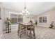 Bright dining area showcasing tile floors, large windows, modern lighting, and ample space for Gathering and guests at 1583 N Constellation Ct, Gilbert, AZ 85234